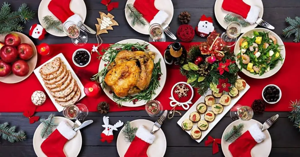 Turkey on Table with apples, salad, sides decorated in seasonal festive decor