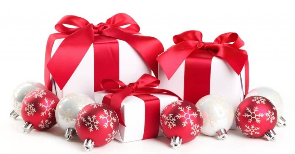 White presents with red ribbon and baubles - Best Christmas gifts for couples who have everything