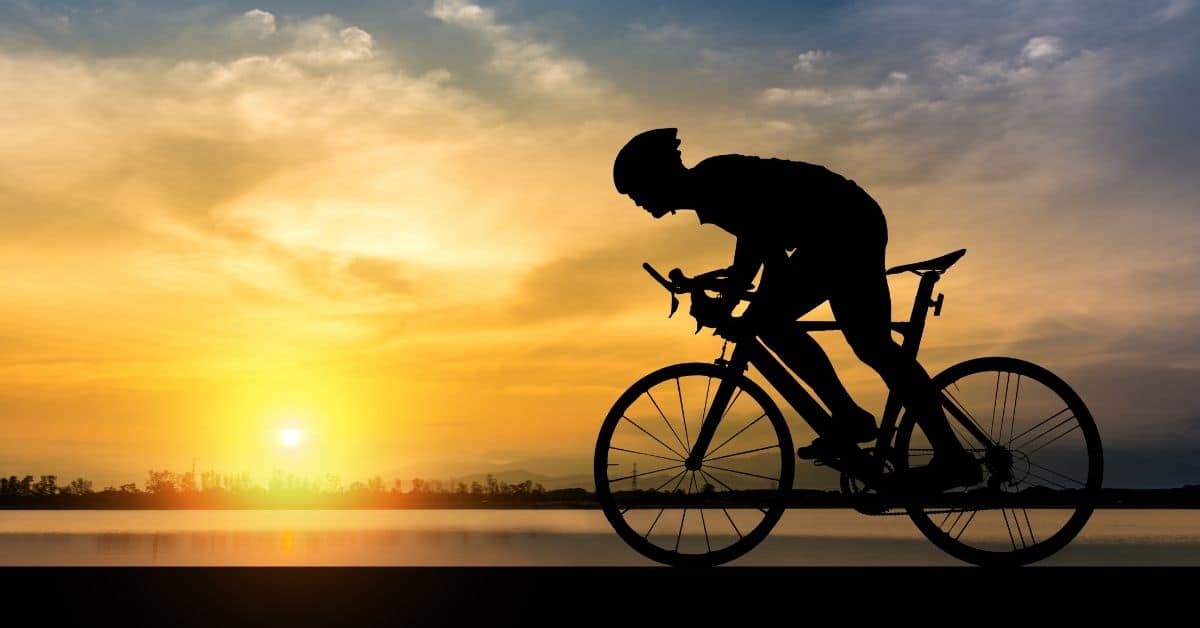 Man on a Bike in the sunset - Best Cycling Gifts for Him UK - Open for Christmas